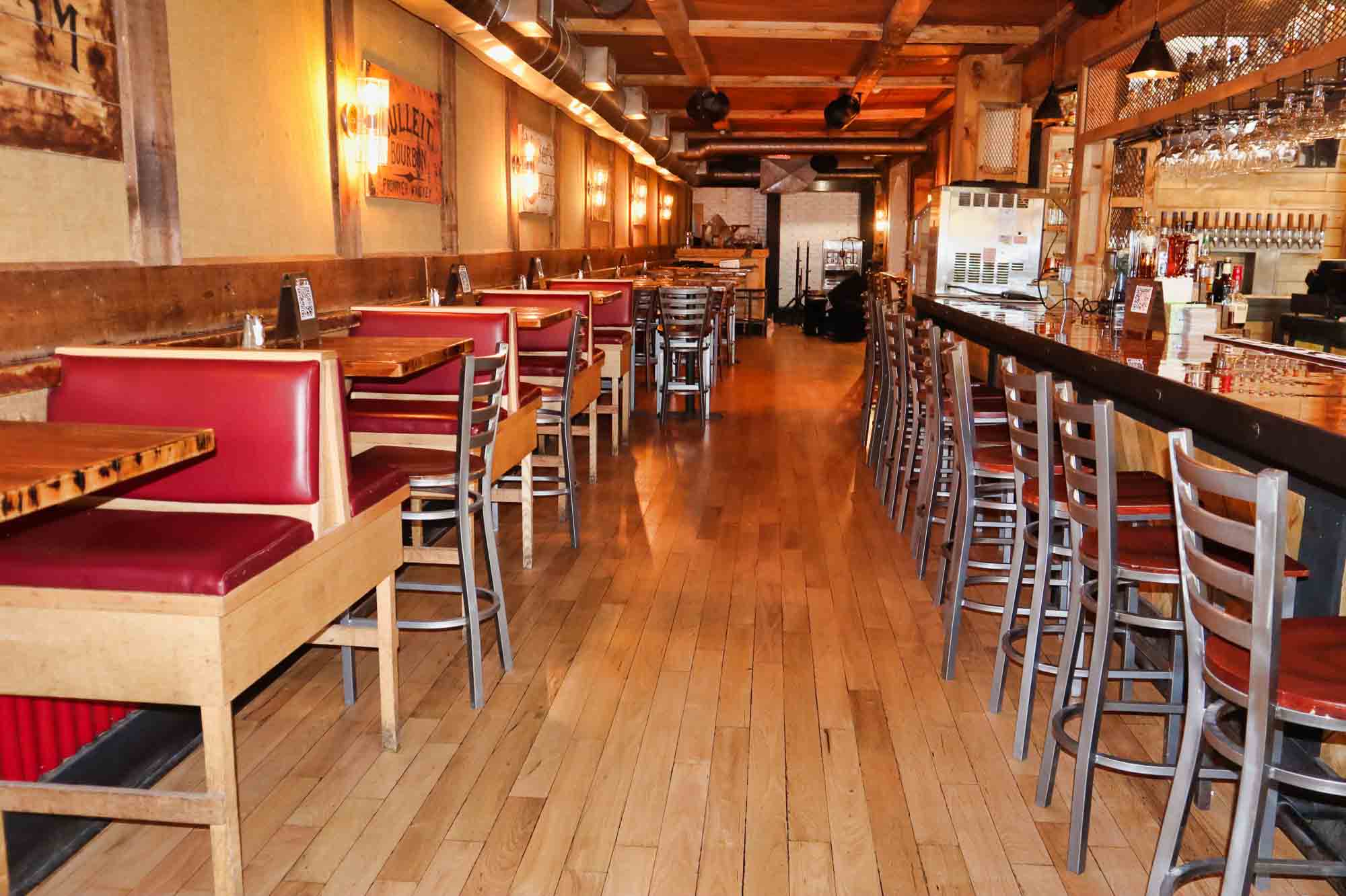 Main dining room with red booths and full bar