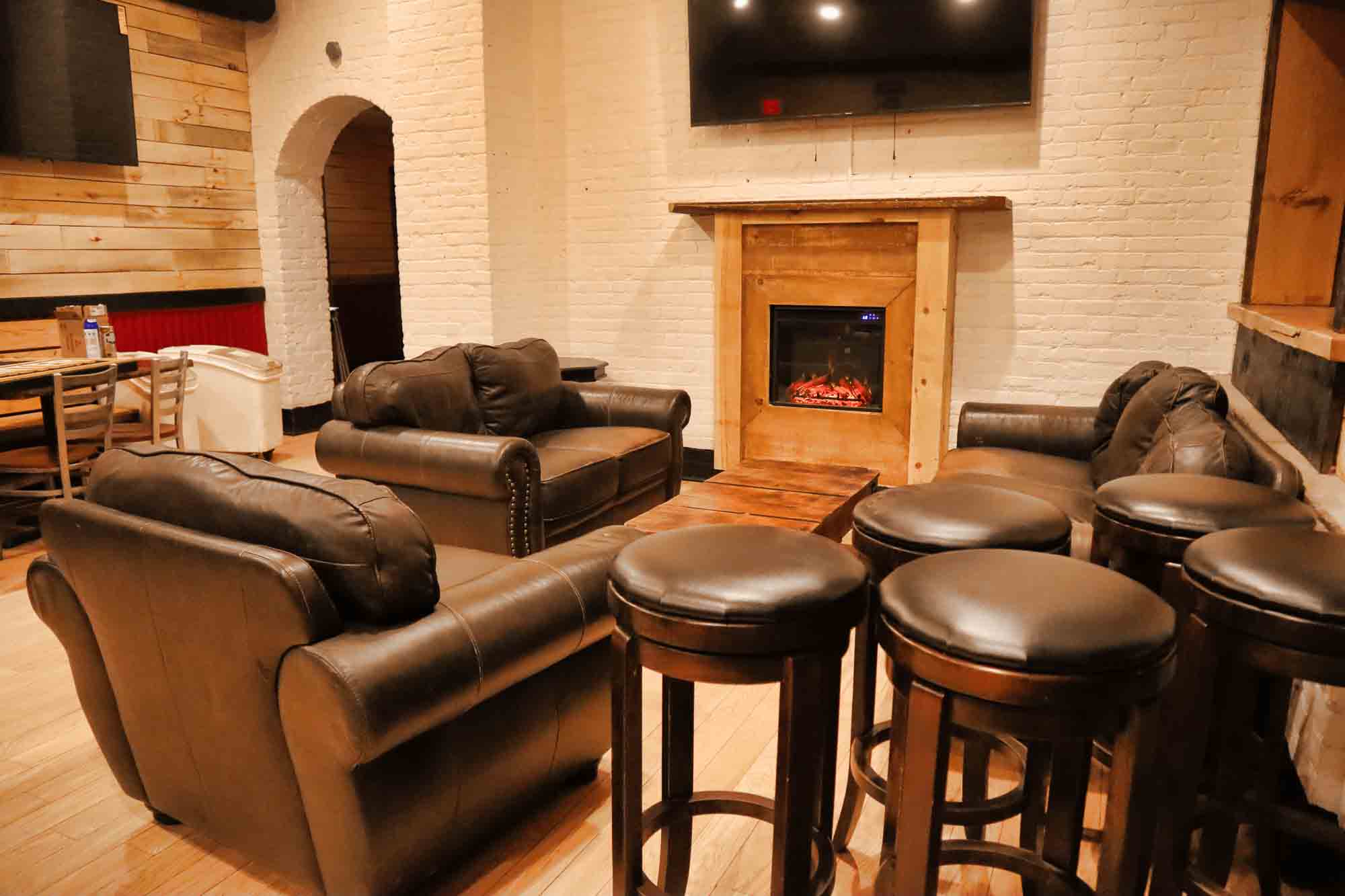 Lounge area with leather couches and fireplace